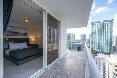 a bedroom with a bed on a balcony at LUXURY 3 Bedrooms BRICKELL BAY APARTMENT in Miami