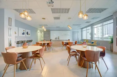 a dining room with tables and chairs and windows at LUXURY 3 Bedrooms BRICKELL BAY APARTMENT in Miami