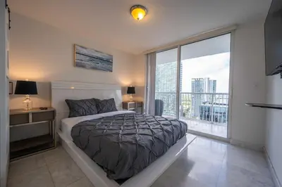 a bedroom with a bed and a large window at LUXURY 3 Bedrooms BRICKELL BAY APARTMENT in Miami