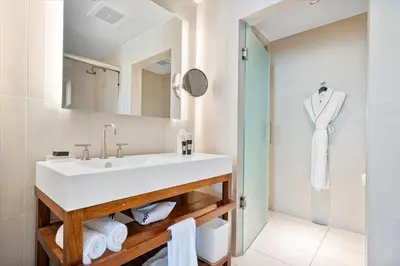 a bathroom with a white sink and a shower at W Residences 2 Bedroom Suite condo in Fort Lauderdale