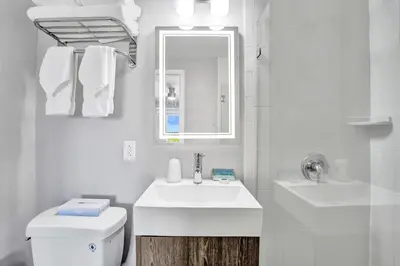 a white bathroom with a sink and a toilet at Hotel Sheldon in Hollywood