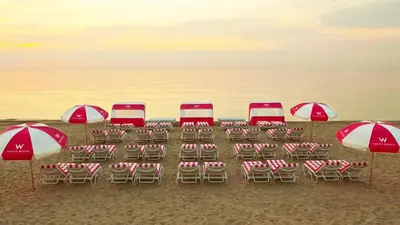 a group of chairs and umbrellas on a beach at W SOUTH BEACH Residences Private King Studio in Miami Beach