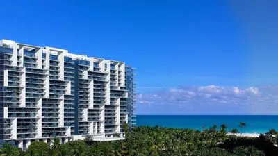 a large apartment building with the ocean in the background at W SOUTH BEACH Residences Private King Studio in Miami Beach