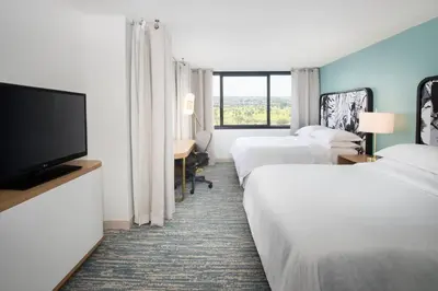 a hotel room with two beds and a flat screen tv at Sheraton Miami Airport Hotel and Executive Meeting Center in Miami