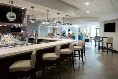 a bar with chairs and a counter in a restaurant at Sheraton Miami Airport Hotel and Executive Meeting Center in Miami
