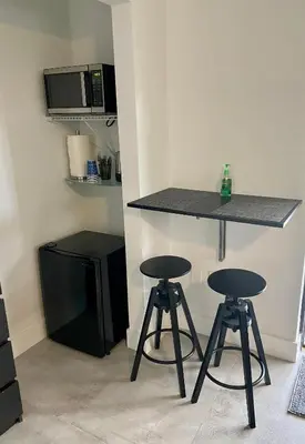 a kitchen with two bar stools and a counter at LYZ Miami in Miami