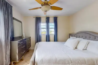 a bedroom with a bed and a ceiling fan at Samira's South Beach Paradise in Miami Beach