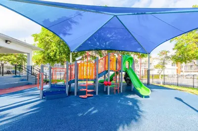 a playground with a slide in a park at PRAIA Hotel Boutique & Apartments Miami Beach in Miami Beach