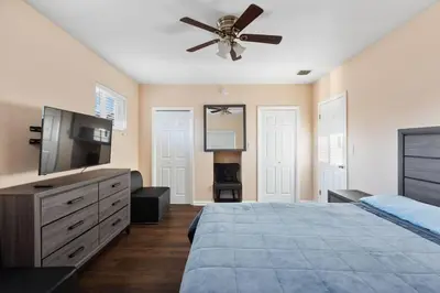 a bedroom with a bed and a ceiling fan at Tranquil Retreat with HEATED POOL Minutes to the Beach in Dania Beach