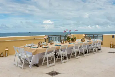 a table on a balcony with the ocean in the background at The Atlantic Hotel & Spa in Fort Lauderdale