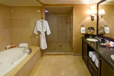 a bathroom with a tub and a shower and a sink at The Atlantic Hotel & Spa in Fort Lauderdale