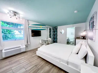 a bedroom with a white bed and a window at Aqua Hotel in Fort Lauderdale