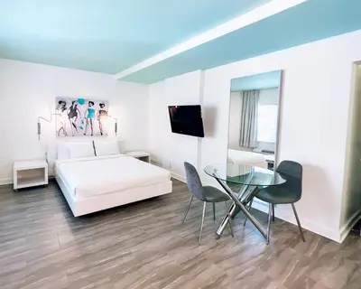 a bedroom with a bed and a glass table at Aqua Hotel in Fort Lauderdale