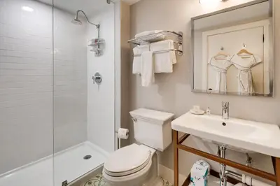 a bathroom with a toilet and a sink and a shower at The Savoy Hotel & Beach Club in Miami Beach