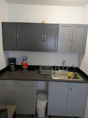 a kitchen counter with gray cabinets and a sink at Welcome Heart and Reliable Heart Vacation Houses in Miami