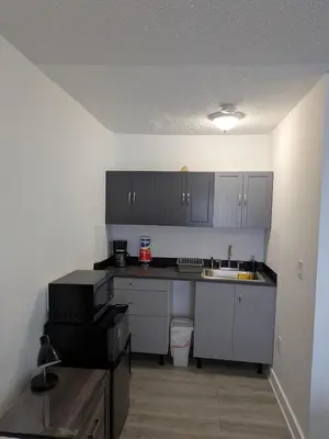 a kitchen with white cabinets and a counter top at Welcome Heart and Reliable Heart Vacation Houses in Miami