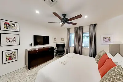 a bedroom with a bed and a ceiling fan at Designer Delight in Fort Lauderdale