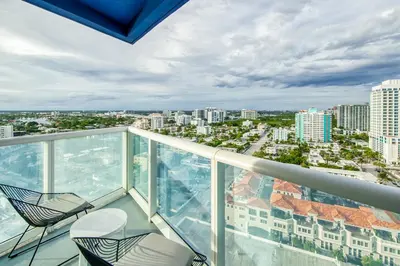 a balcony with two chairs and a view of the city at The Residency at Fort Lauderdale in Fort Lauderdale