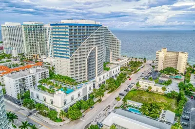 an aerial view of a large building in front of the ocean at The Residency at Fort Lauderdale in Fort Lauderdale