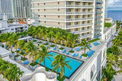 an aerial view of the resort with a pool and palm trees at The Residency at Fort Lauderdale in Fort Lauderdale