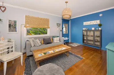 a living room with a couch and a coffee table at Cozy Cottage Near Beach in Hollywood