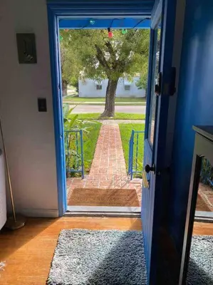 an open door leading to a brick walkway at Cozy Cottage Near Beach in Hollywood
