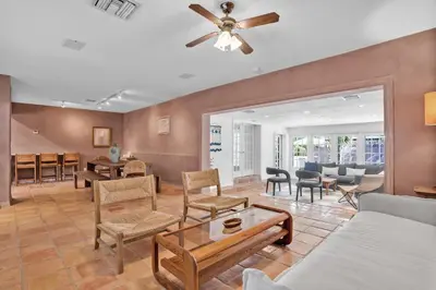 a living room with furniture and a ceiling fan at NEWLY RENOVATED POOL, HOT TUB, & EPIC BACKYARD in Fort Lauderdale