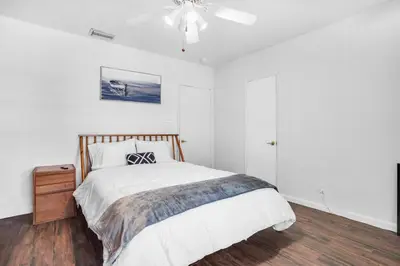 a bedroom with a bed and a ceiling fan at NEWLY RENOVATED POOL, HOT TUB, & EPIC BACKYARD in Fort Lauderdale