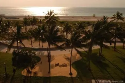 an aerial view of a beach with palm trees at NEW Amazing large 3BR direct oceanfront Penthouse On Ocean Drive!! in Miami Beach