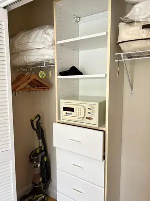 a closet with a microwave and a bed at NEW Amazing large 3BR direct oceanfront Penthouse On Ocean Drive!! in Miami Beach