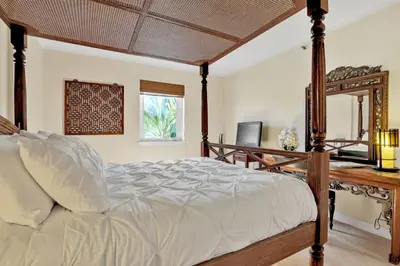 a bedroom with a large bed and a mirror at NEW Amazing large 3BR direct oceanfront Penthouse On Ocean Drive!! in Miami Beach