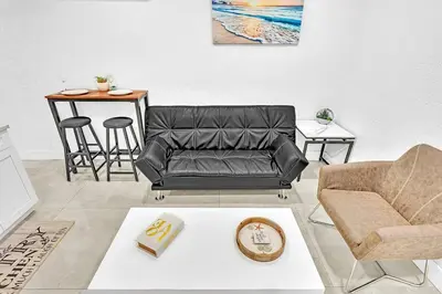 a living room with a couch and a table at Boutique One Bdrm Close To Aventura Mall & Beach in Hallandale Beach