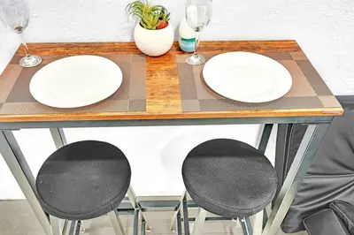two white plates on a table with two chairs at Boutique One Bdrm Close To Aventura Mall & Beach in Hallandale Beach