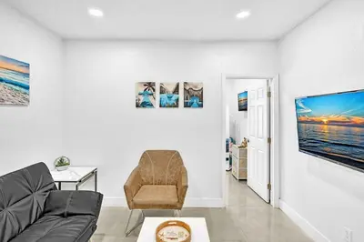 a living room with a couch and a tv at Boutique One Bdrm Close To Aventura Mall & Beach in Hallandale Beach