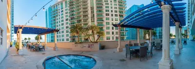 a building with a hot tub in the middle of a patio at Studios in Brickell with Pool, Gym, free parking and Game Room in Miami