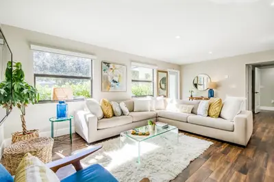 a living room with a couch and a table at Mid-Century Modern Oasis in Miami