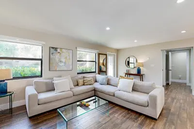 a living room with a couch and a table at Mid-Century Modern Oasis in Miami