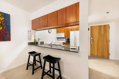 a kitchen with a counter and stools in a room at Luxury 1BD Apt in Downtown Brickell free parking in Miami