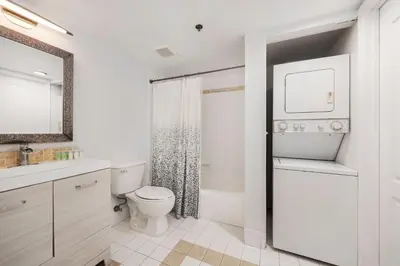 a white bathroom with a toilet and a sink at 1Bd Apt with Free Parking and Amazing View in Miami