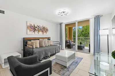 a bedroom with a bed and a living room at Yacht Club Miami Suite 2 Bedroom and 2 Bathroom With Baby Crib & Free Parking in Miami