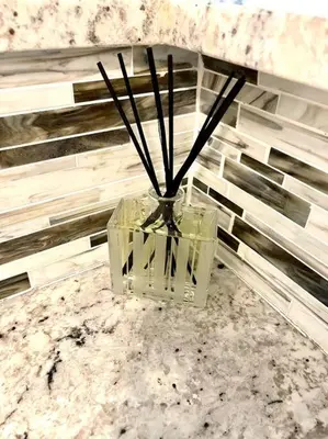 a glass vase with sticks in it on a table at Yacht Club Miami Suite 2 Bedroom and 2 Bathroom With Baby Crib & Free Parking in Miami