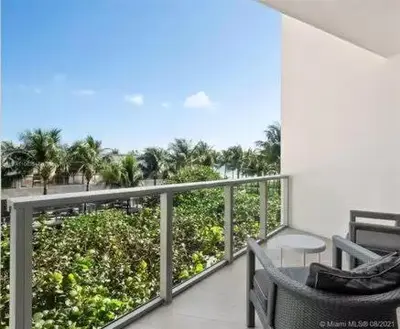 a balcony with two chairs and a view of the ocean at Residences Suite South Beach in Miami Beach