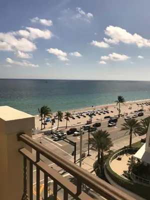a view of the beach from the balcony of a resort at The Atlantic Hotel & Spa Condo in Fort Lauderdale