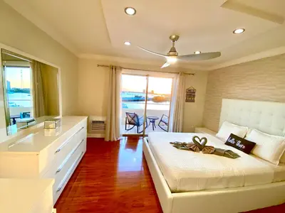 a bedroom with a bed with a dresser and a window at Deluxe waterfront one bedroom apartment with Miami Skyline view, free parking 5 mins drive to Miami Beach in Miami Beach