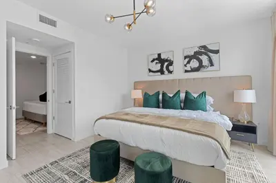 a bedroom with a large bed with green pillows at LUXURY 1 BDRM/1B APT IN MIAMI DESIGN DISTRICT AREA in Miami