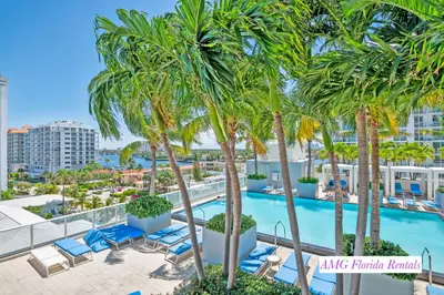 a view of a swimming pool with palm trees and lounge chairs at Luxury 1 BR at Fort Lauderdale in Fort Lauderdale