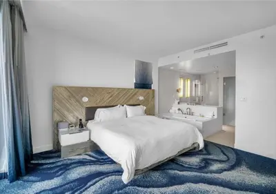 a large bedroom with a large bed and a bathroom at Luxury 1 BR at Fort Lauderdale in Fort Lauderdale