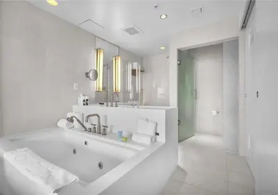a white bathroom with a tub and a sink at Luxury 1 BR at Fort Lauderdale in Fort Lauderdale
