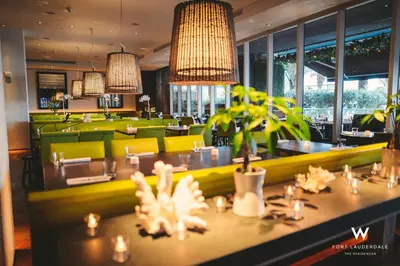 a restaurant with a dining room with green chairs at Luxury 1 BR at Fort Lauderdale in Fort Lauderdale