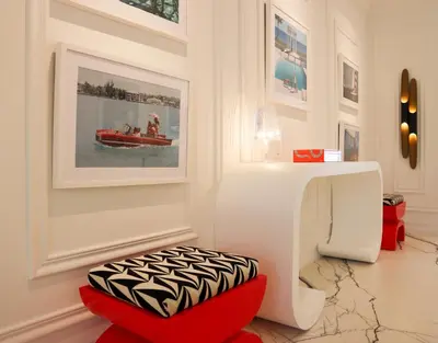 a room with a red ottoman and a red stool at Uma House by Yurbban South Beach in Miami Beach